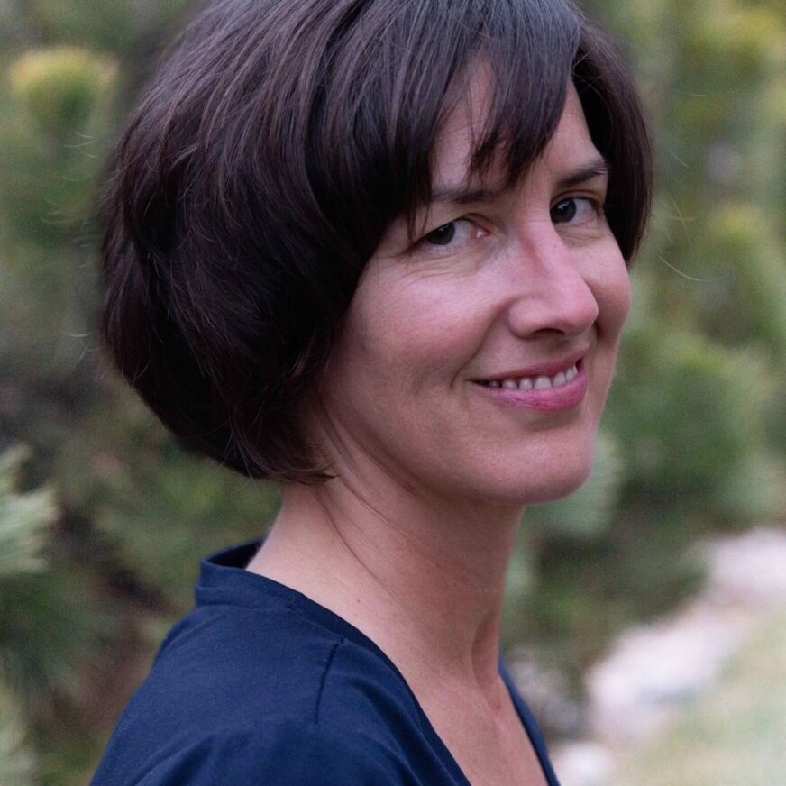 A woman with short hair is smiling for the camera.